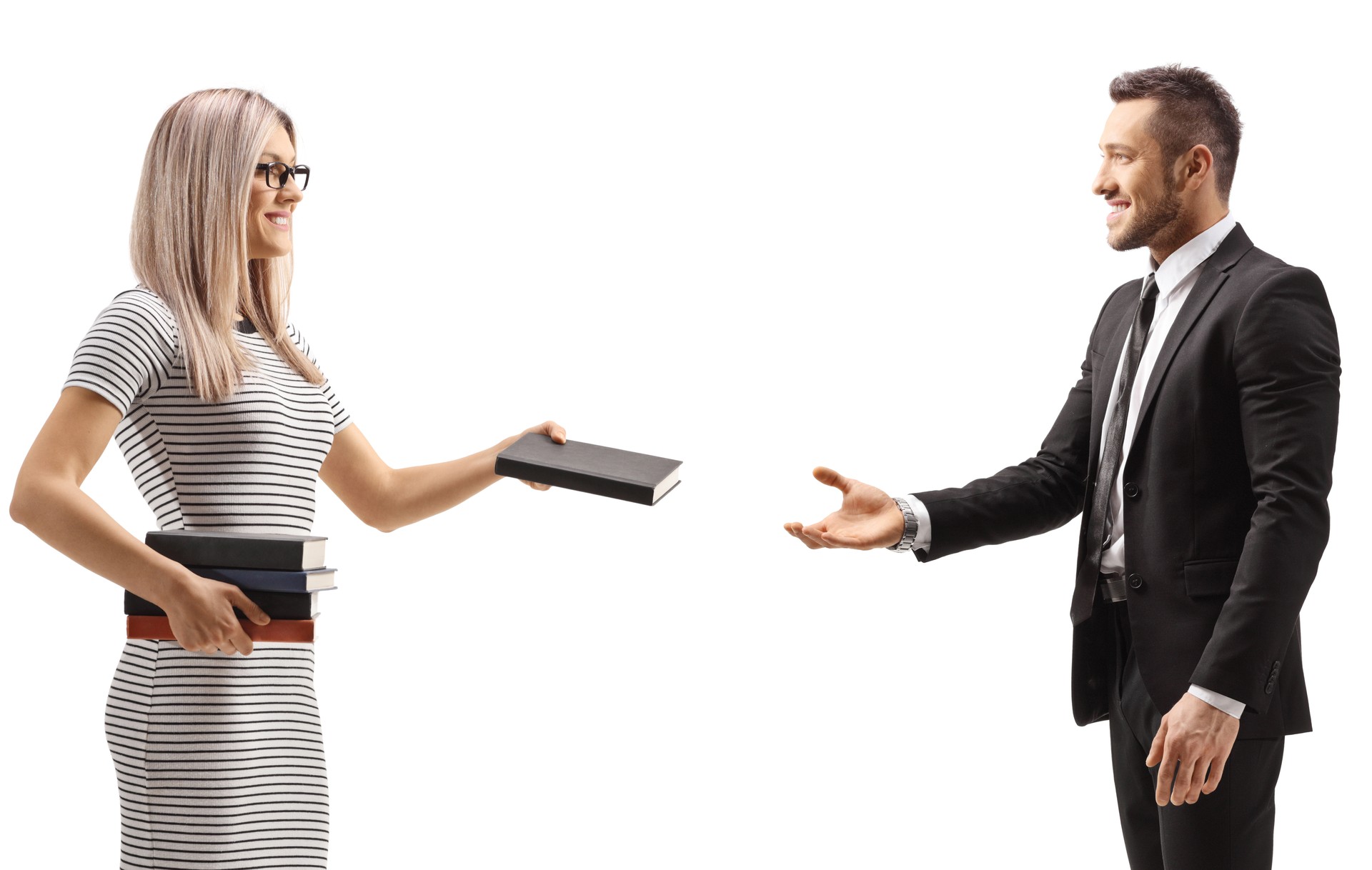 Young female giving a book to a man in a black suit